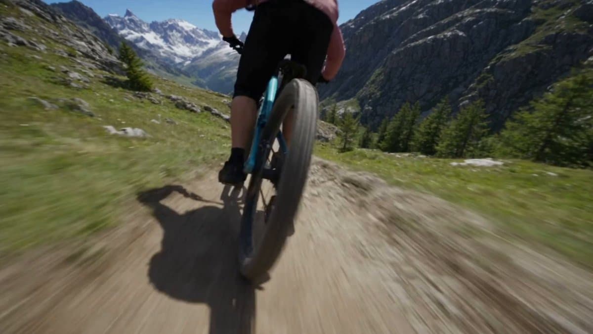 Create an explosive, high-adrenaline extreme mountain-biking action sequence in 