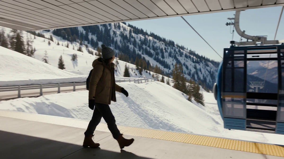 A Western female traveler in her mid-20s, wearing a beige winter jacket, dark hi