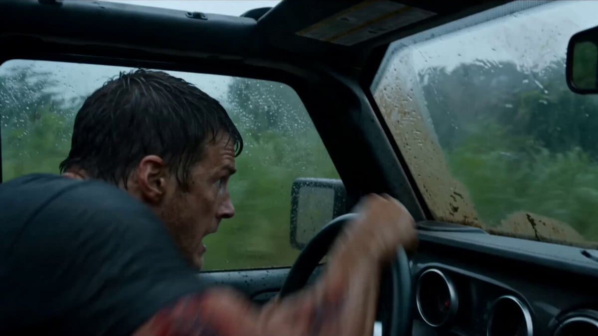 Hyper-real B-movie creature-feature action. Tropical jungle. Heavy rain from a r