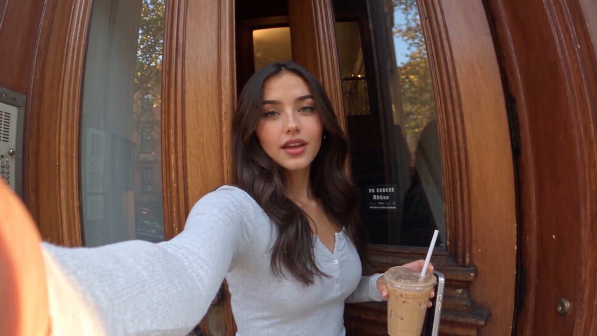 The woman in @Image 1 (identity AND wardrobe reference — keep her exact face, cu
